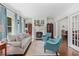 Bright living room featuring large windows, fireplace, hardwood floors, and ample seating at 1036 Oxford Ne Rd, Atlanta, GA 30306