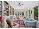 Cozy sun room featuring built-in bookshelves, natural light, and comfortable seating area at 1036 Oxford Ne Rd, Atlanta, GA 30306