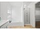 Well-lit bathroom featuring a soaking tub, separate shower, and a window offering natural light at 125 Flatwood, Marietta, GA 30066