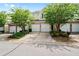 Townhome featuring multi-car garages, manicured landscaping, and partial brick facade at 125 Flatwood, Marietta, GA 30066