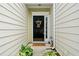 Close-up of a welcoming front door with sidelight and decorative wreath and plants at 125 Flatwood, Marietta, GA 30066