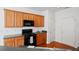 Well-lit kitchen with hardwood floors, wooden cabinets, modern microwave, and a gas stove at 125 Flatwood, Marietta, GA 30066