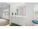 A modern bathroom with double sinks, and a view of the outdoors through the window at 125 Flatwood Trail, Marietta, GA 30066
