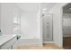 A bright bathroom, featuring a tub and shower combo, white tile and a large window at 125 Flatwood Trail, Marietta, GA 30066