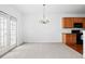 Open dining area featuring a chandelier, French doors, and view of adjacent kitchen at 125 Flatwood Trail, Marietta, GA 30066