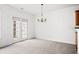 Open dining area with view of french doors and chandelier at 125 Flatwood Trail, Marietta, GA 30066