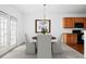 Dining area with French doors, modern chandelier, and adjacent kitchen area at 125 Flatwood Trail, Marietta, GA 30066