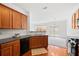 Updated kitchen with black appliances, wood cabinetry, and seamless access to dining area at 125 Flatwood Trail, Marietta, GA 30066