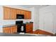 Modern kitchen featuring wooden cabinetry, appliances, and hardwood flooring at 125 Flatwood Trail, Marietta, GA 30066