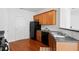 Kitchen with wood cabinets, black appliances, and hardwood floors at 125 Flatwood Trail, Marietta, GA 30066