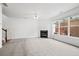 Bright living room with a fireplace, staircase, and large window, offering a versatile living area at 125 Flatwood Trail, Marietta, GA 30066