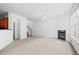 Open living room with fireplace, neutral paint, and stairway access to upper level at 125 Flatwood Trail, Marietta, GA 30066