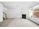 Spacious living room with a fireplace, large window, and neutral carpet at 125 Flatwood Trail, Marietta, GA 30066