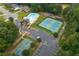 Aerial view showcases community amenities including a pool, tennis courts, basketball court, playground, and clubhouse at 192 Sandhurst Ct, Suwanee, GA 30024