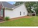Spacious backyard featuring lush green lawn, manicured flower beds, and a well-maintained exterior at 192 Sandhurst Ct, Suwanee, GA 30024
