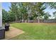 Expansive, well-maintained backyard featuring a lush lawn, mature trees, and a patio area perfect for outdoor entertaining at 192 Sandhurst Ct, Suwanee, GA 30024