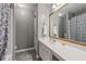 Clean bathroom featuring a vanity with ample storage, framed mirror, and a shower with patterned curtain at 192 Sandhurst Ct, Suwanee, GA 30024