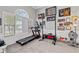 Bright exercise room with a treadmill, weight rack, and natural light, perfect for workouts at 192 Sandhurst Ct, Suwanee, GA 30024
