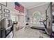 Bright exercise room with a treadmill, weight rack, and natural light, perfect for workouts at 192 Sandhurst Ct, Suwanee, GA 30024
