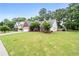 Spacious front yard showcasing a brick home with an attached garage and manicured landscaping at 192 Sandhurst Ct, Suwanee, GA 30024