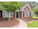 Inviting front entrance with a brick pathway, manicured landscaping, and charming architectural details at 192 Sandhurst Ct, Suwanee, GA 30024