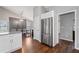Modern kitchen with stainless steel refrigerator, ample storage, and adjacent dining area at 192 Sandhurst Ct, Suwanee, GA 30024