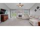 Comfortable living room featuring a fireplace, French doors to the backyard, and plush sectional at 192 Sandhurst Ct, Suwanee, GA 30024