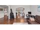Inviting living room with hardwood floors, modern lighting, and a view into the dining and living areas at 192 Sandhurst Ct, Suwanee, GA 30024