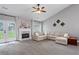 Bright living room featuring a fireplace, neutral paint, plush carpet, and access to the outdoor area at 192 Sandhurst Ct, Suwanee, GA 30024