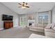 Cozy living room with fireplace, french doors to back yard, and plush carpeting at 192 Sandhurst Ct, Suwanee, GA 30024