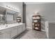 Bright main bathroom features double sinks, a large mirror, and ample storage for toiletries and linens at 192 Sandhurst Ct, Suwanee, GA 30024