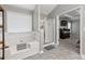 Well-lit main bathroom with a soaking tub, separate glass shower, and stylish fixtures for a spa-like feel at 192 Sandhurst Ct, Suwanee, GA 30024