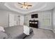 Spacious main bedroom offers a tray ceiling, carpeting, and an adjoining bathroom with modern fixtures at 192 Sandhurst Ct, Suwanee, GA 30024
