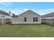 A backyard of a light colored home with a simple design and a wooden fence at 2022 Patterson Park Dr, Lawrenceville, GA 30044