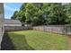 Large fenced backyard featuring a lush lawn and mature trees at 2022 Patterson Park Dr, Lawrenceville, GA 30044