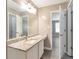 Bathroom with granite counters, single sink, and wood look floors at 2022 Patterson Park Dr, Lawrenceville, GA 30044