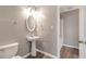 Clean bathroom with pedestal sink, modern lighting, and a shower/tub combination at 2022 Patterson Park Dr, Lawrenceville, GA 30044