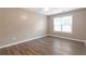 Neutral bedroom with ceiling fan, natural light, wood-look flooring, and ample space at 2022 Patterson Park Dr, Lawrenceville, GA 30044