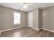 Bedroom with wood look floors, ceiling fan, and natural light from window at 2022 Patterson Park Dr, Lawrenceville, GA 30044