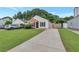 Charming single-story home featuring a brick facade, well-manicured lawn and long driveway at 2022 Patterson Park Dr, Lawrenceville, GA 30044