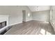 Open living room with wood-look floors, fireplace, and access to other areas of the home at 2022 Patterson Park Dr, Lawrenceville, GA 30044