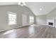 Bright living room with vaulted ceiling, fireplace, and modern gray wood-look flooring at 2022 Patterson Park Dr, Lawrenceville, GA 30044