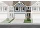 Charming blue two-story townhouse with attached garage and well-manicured front lawn at 422 Lanier Cir, Woodstock, GA 30189