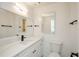 Modern bathroom with dual mirrors, white vanity, solid countertop and matte black hardware fixtures at 4244 Lindsey Dr, Decatur, GA 30035