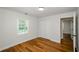 Bright bedroom with wood-look flooring, white walls, closet and natural light from the window at 4244 Lindsey Dr, Decatur, GA 30035