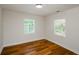 Bright bedroom features natural light from two windows and warm wood-look flooring at 4244 Lindsey Dr, Decatur, GA 30035