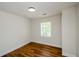 Cozy bedroom with a large window and wood-look flooring; neutral color palette at 4244 Lindsey Dr, Decatur, GA 30035
