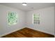 Serene bedroom with natural light from two windows and warm wood-look flooring at 4244 Lindsey Dr, Decatur, GA 30035