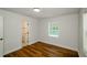 Inviting bedroom featuring wood-look floors, natural light, and a closet at 4244 Lindsey Dr, Decatur, GA 30035