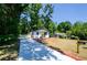 Inviting home showcasing a lengthy driveway, complemented by lush landscaping and a charming yellow front door at 4244 Lindsey Dr, Decatur, GA 30035